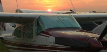 Oshkosh's sunset over Jim Gandee's Centurion at Cessna Base Camp. Click on for a larger image.